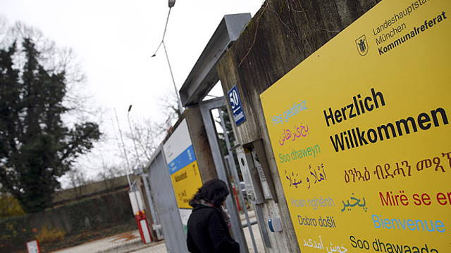  A woman walks into the former German army base "Bayernkaserne" which has been converted into a refugee camp in Munich Photo: MICHAEL DALDER/REUTERS