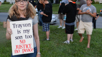 Connellly Stewart of Frederick holds the sign she brought to the march for Trayvon Martin as people gathered in a field off Burke St. in Frederick, Md. Tuesday night July 16, 2013. About 200 marchers took to the streets of downtown Frederick. (AP Photo/The Frederick News-Post,Sam Yu)