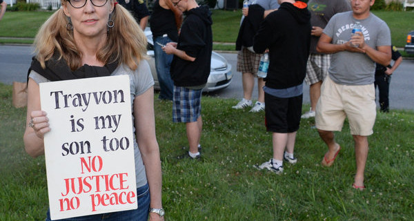 Connellly Stewart of Frederick holds the sign she brought to the march for Trayvon Martin as people gathered in a field off Burke St. in Frederick, Md. Tuesday night July 16, 2013. About 200 marchers took to the streets of downtown Frederick. (AP Photo/The Frederick News-Post,Sam Yu)