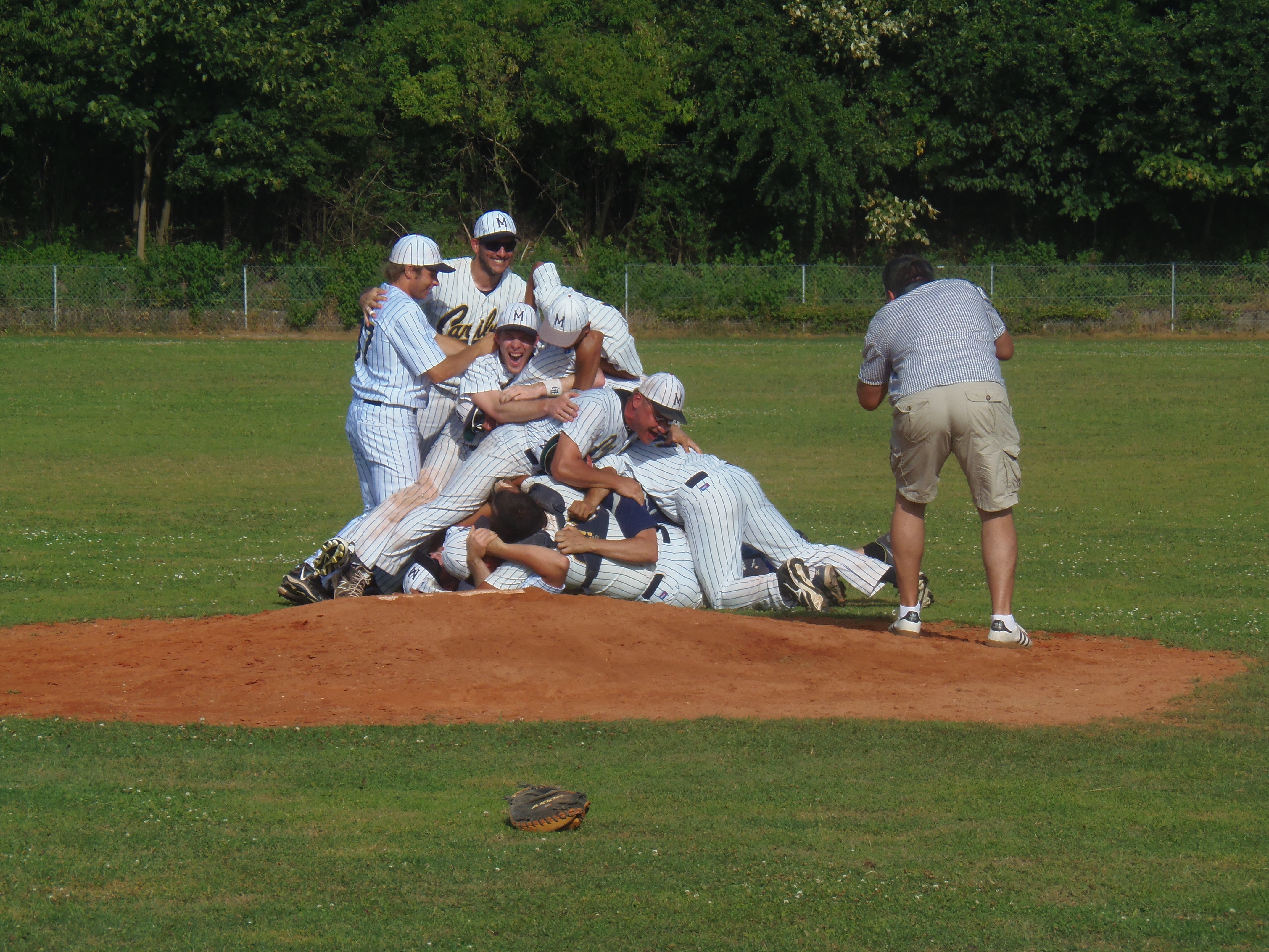 The Munich Caribes baseball players celebrate with a traditional pile-up on the pitcher's mound after clinching the Regionalliga championship on Saturday.
Photo: Douglas Sutton