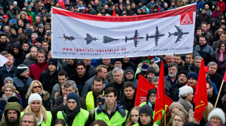 Employees of Cassidian, an affiliate of the aviation concern EADS, protest in front of the works against the planned cutbacks in Manching, Germany, 28 November 2013. Photo: DANIEL KARMANN