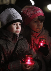 Ukrainian children hold candles during a memorial ceremony near of a monument to the victims of the Great Famine in Kiev, 24 November 2012. Reports state that Ukrainians light candles to mark a day of memory for the victims of the Holodomor in 1932-1933. The Holodomor was a manmade famine provoked by Soviet dictator Josef Stalin. The result was the death to more than five million Ukrainians. EPA/SERGEY DOLZHENKO