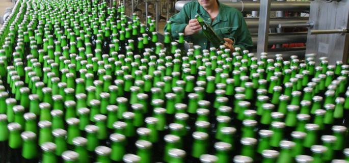 Worker Olaf Wehrbrink checks a bottle of Beck's beer in the Beck brewery bottling plant in Bremen, northwest Germany, in this Aug. 8, 2001 file picture. German beer sales rose slightly in the first half of 2004 as exports grew, but consumption at home declined, according to statistic reports released, Wednesday, July 28, 2004. (AP Photo/Joerg Sarbach)