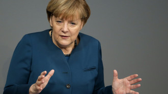 German Chancellor Angela Merkel gestures during a government statement about Europe at the German federal parliament, Bundestag, in Berlin, Germany, Wednesday, Dec. 18, 2013. (AP Photo/Michael Sohn)