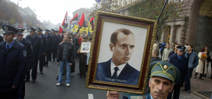A partisan veteran from the Ukrainian Insurgent Army carries a portrait of Ukrainian Insurgent Army leader Stepan Bandera during a march in Kiev.  (AP Photo/Efrem Lukatsky)